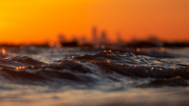 Blurry city skyline sunset waves free wallpaper for desktop - medium preview image