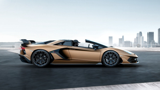 Gold sports car city skyline free wallpaper for desktop - medium preview image