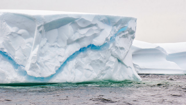 Large iceberg ocean shore boat free wallpaper for desktop - medium preview image