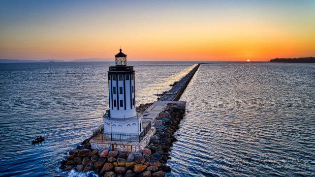 Lighthouse pier ocean sunset romanticism free wallpaper for desktop - medium preview image