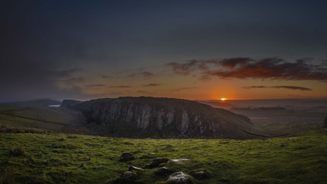 Sunset grassy field mountain cloudy free wallpaper for desktop - medium preview image