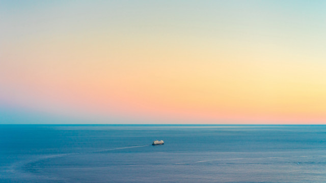 Ocean sunset hazy minimalism boat free wallpaper for desktop - medium preview image