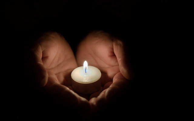 Person holding lit candle dark #3 free wallpaper for desktop - medium preview image