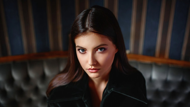 Woman blackjacket couch blueeyes portrait free wallpaper for desktop - medium preview image