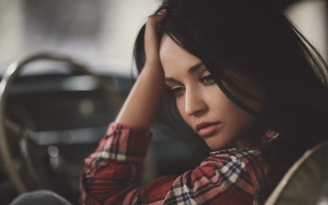 Woman sitting serious blurry outdoors free wallpaper for desktop - medium preview image