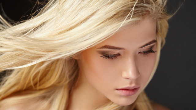 Blonde woman blowing wind closed free wallpaper for desktop - medium preview image