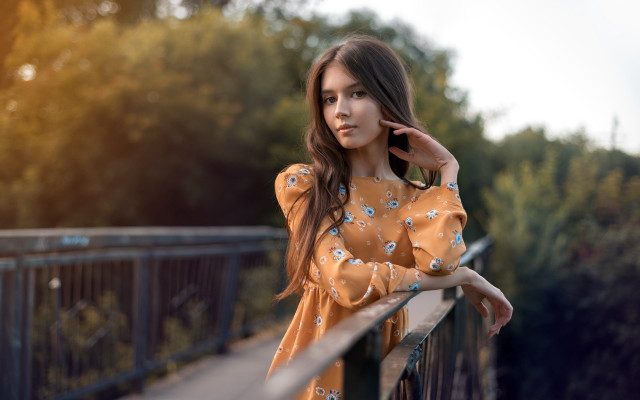 Woman leaning on rail serious free wallpaper for desktop - medium preview image