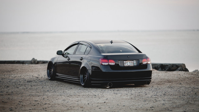 Black car gravel road ocean free wallpaper for desktop - medium preview image