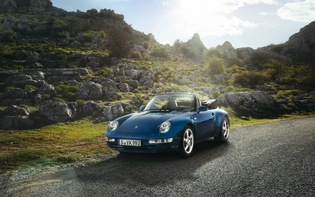 Blue sports car rocky hillside free wallpaper for desktop - medium preview image