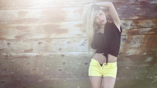 Woman yellow shorts black shirt free wallpaper for desktop - medium preview image