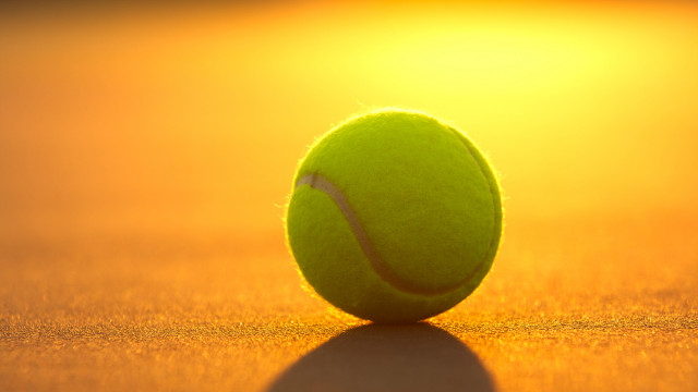 Tennis ball sitting court sunset free wallpaper for desktop - medium preview image