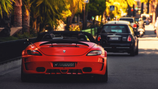 Red sports car driving black free wallpaper for desktop - medium preview image