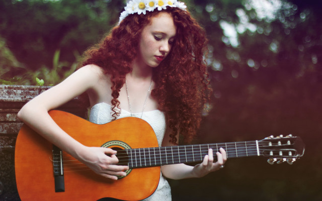 Redhead woman playing guitar outside free wallpaper for desktop - medium preview image