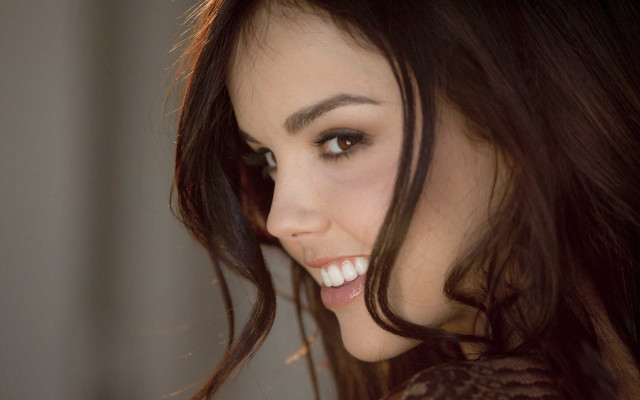 Woman smiling wind hair cellphone free wallpaper for desktop - medium preview image