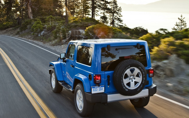Blue jeep driving forest hillside free wallpaper for desktop - medium preview image