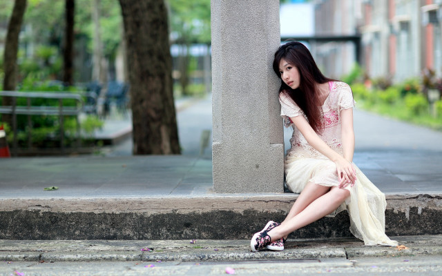 Woman sitting building tree sidewalk free wallpaper for desktop - medium preview image