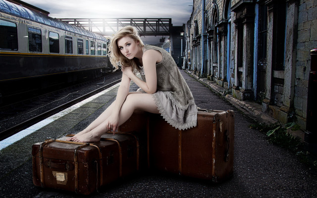 Woman sitting suitcase train station free wallpaper for desktop - medium preview image