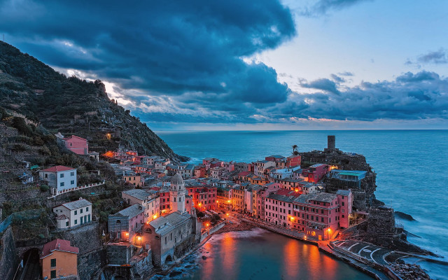 Cliffside town ocean night city free wallpaper for desktop - medium preview image