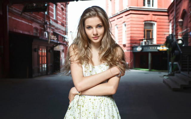 Serious woman street crossed arms free wallpaper for desktop - medium preview image