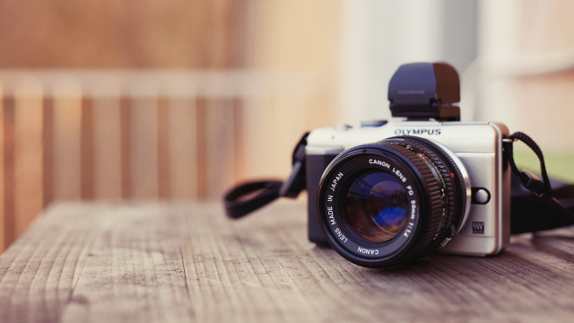 Camera lens wooden table photorealism free wallpaper for desktop - medium preview image