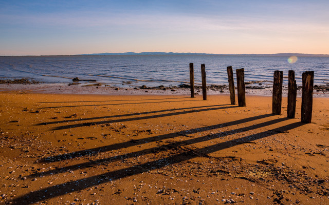 Wooden posts beach sunset ocean free wallpaper for desktop - medium preview image