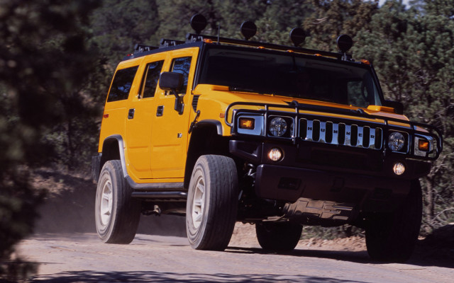 Yellow hummer dirt road woods free wallpaper for desktop - medium preview image