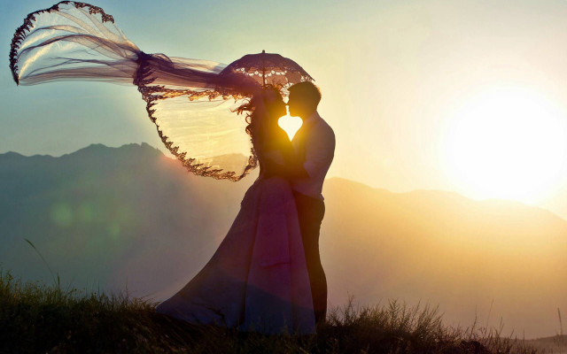 Couple kissing umbrella sunset mountains free wallpaper for desktop - medium preview image