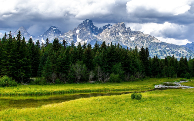 Grassy field stream mountains clouds free wallpaper for desktop - medium preview image