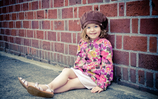 Little girl brick wall smiling #2 free wallpaper for desktop - medium preview image