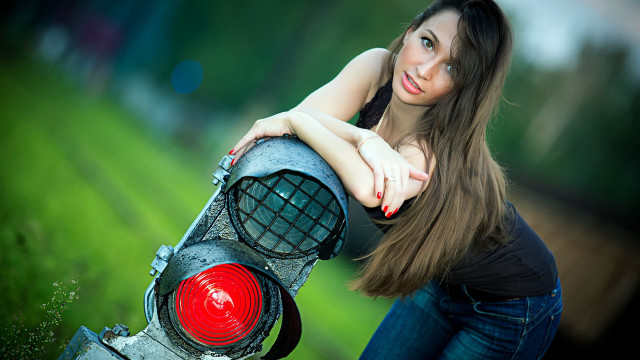 Woman leaning trafficlight grass field free wallpaper for desktop - medium preview image