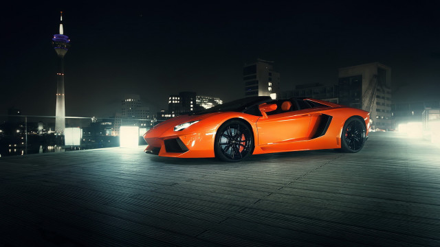 Bright orange sports car city free wallpaper for desktop - medium preview image