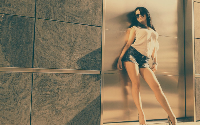 Woman leaning wall heels denim free wallpaper for desktop - medium preview image