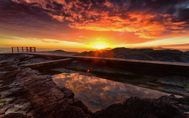 Rocky beach sunset ocean lighthouse free wallpaper for desktop - medium preview image