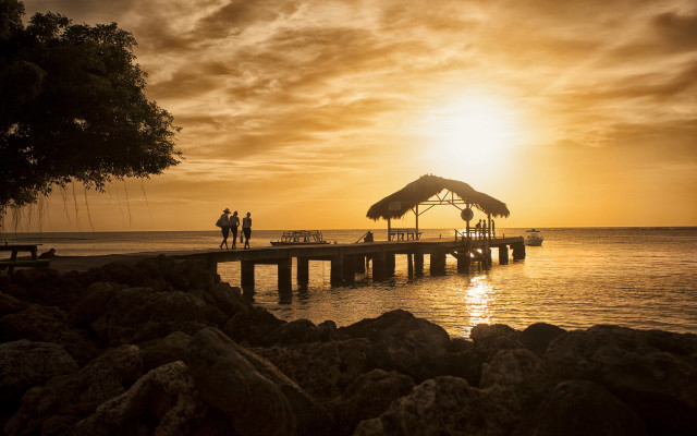 Pier thatched roof sunset people free wallpaper for desktop - medium preview image