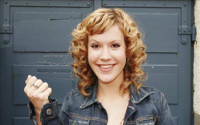 Curly hair denim jacket smiling free wallpaper for desktop - medium preview image