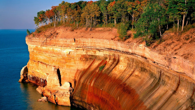 Cliff face trees ocean cave free wallpaper for desktop - medium preview image