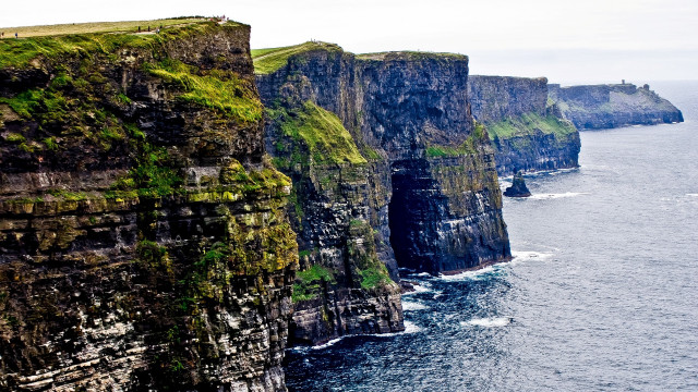 Cliff grassy ocean cityscape starry free wallpaper for desktop - medium preview image