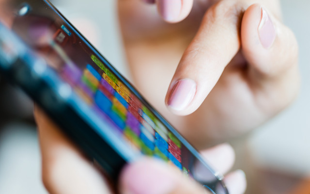 Woman holding cellphone blurry background free wallpaper for desktop - medium preview image