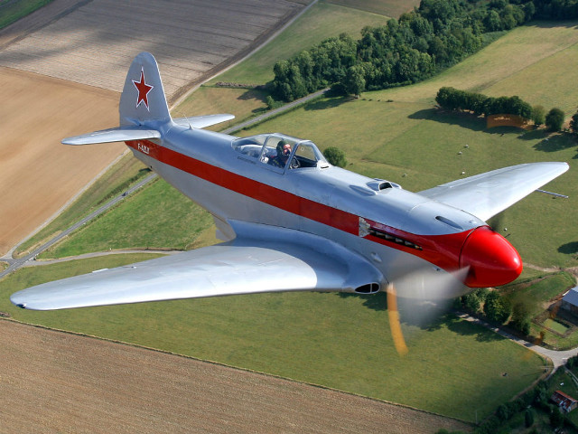 Red white airplane over green free wallpaper for desktop - medium preview image