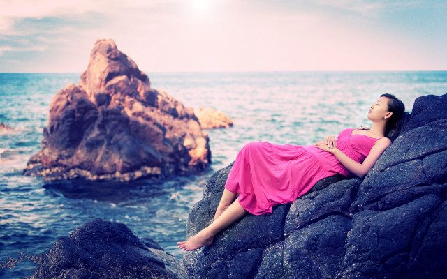 Pink dress woman laying rock free wallpaper for desktop - medium preview image