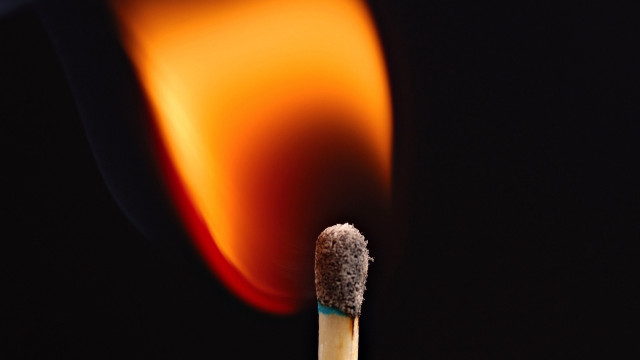Matchstick lit flame dark background free wallpaper for desktop - medium preview image
