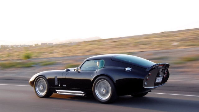 Black sports car hillside road free wallpaper for desktop - medium preview image