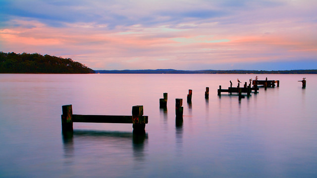 Wooden posts lake sunset boat free wallpaper for desktop - medium preview image