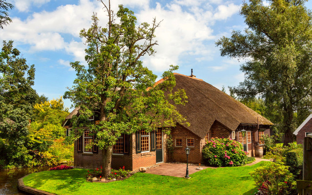 Thatched roof house garden river free wallpaper for desktop - medium preview image
