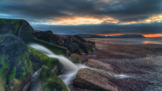 Waterfall rocky cliff sunset reflection free wallpaper for desktop - medium preview image