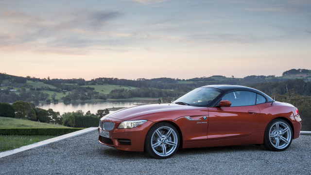 Red sports car lake hill free wallpaper for desktop - medium preview image