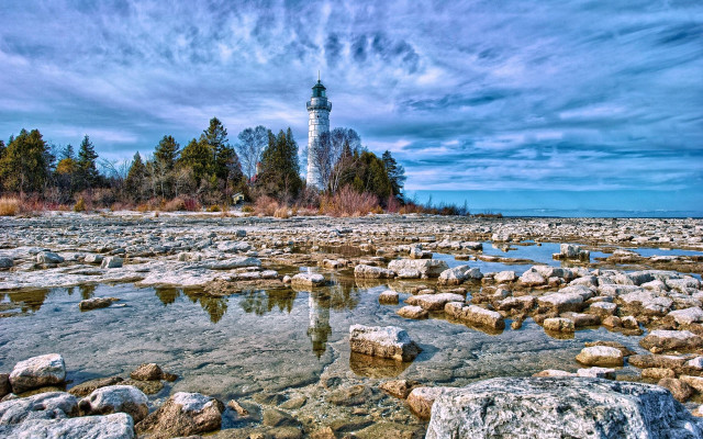 Lighthouse rocky shore trees water free wallpaper for desktop - medium preview image