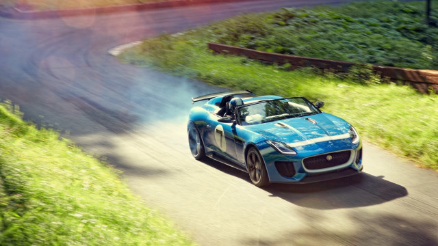 Blue sports car driving green free wallpaper for desktop - medium preview image