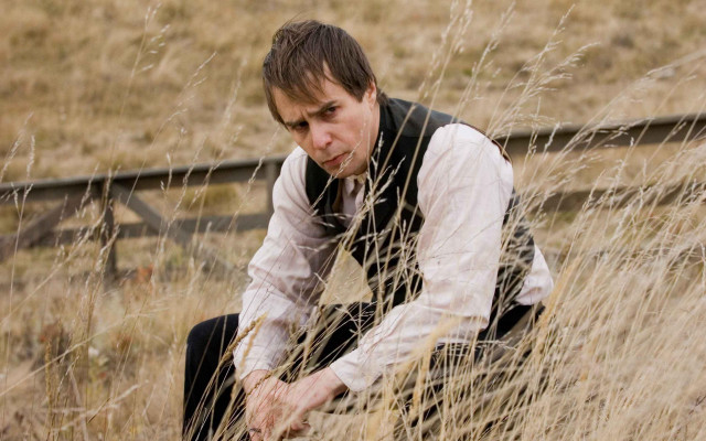 Man kneeling grass field hand free wallpaper for desktop - medium preview image