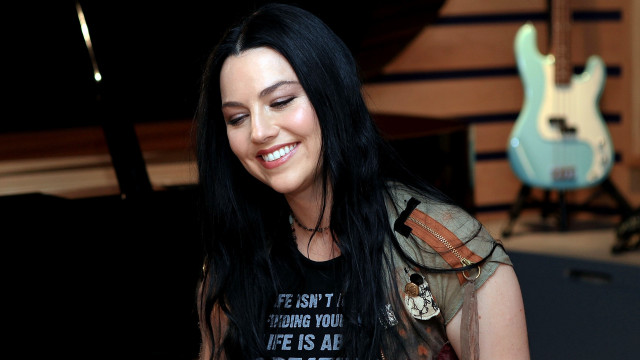 Woman smiling black hair guitar free wallpaper for desktop - medium preview image